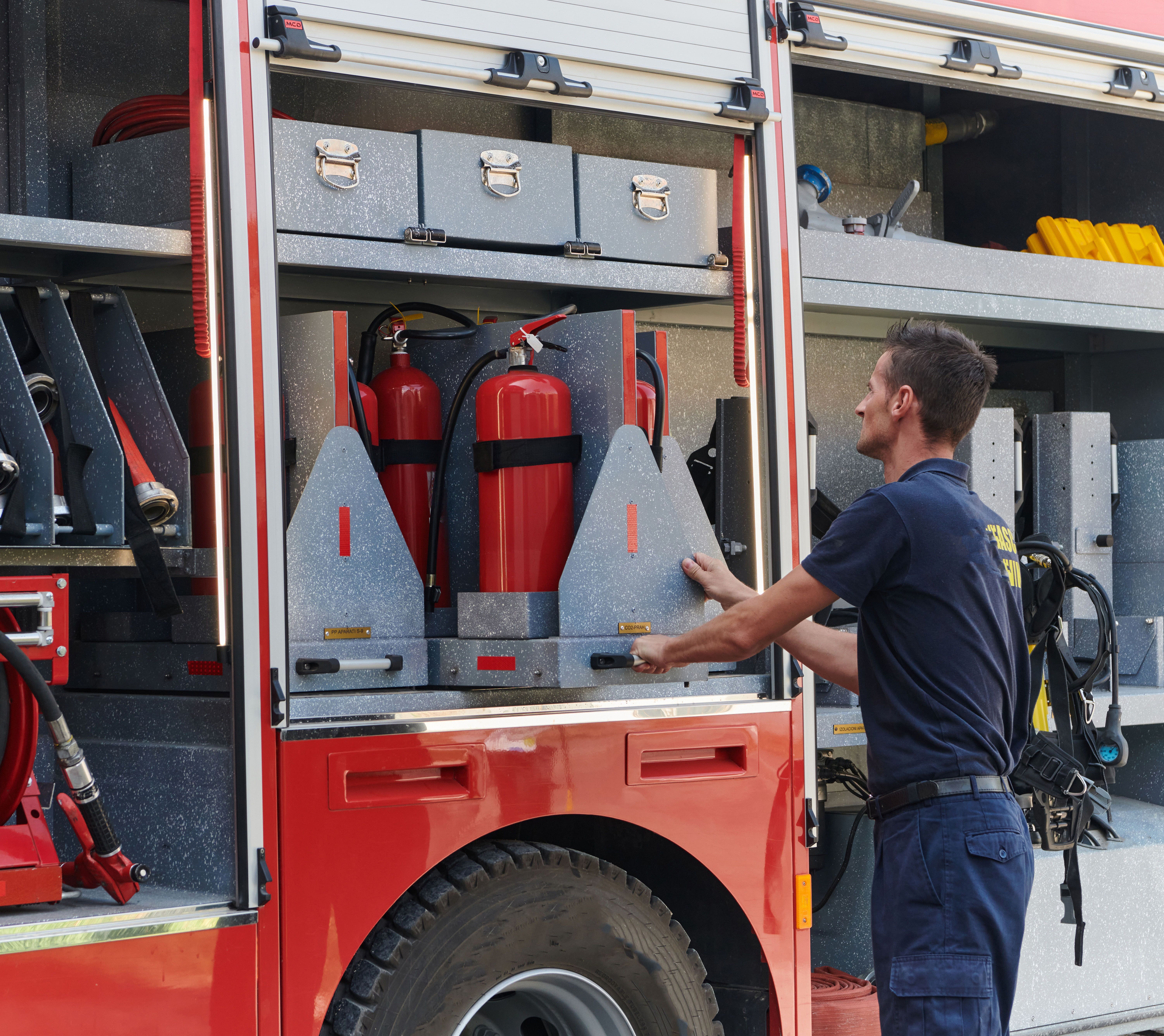 Feuerwehrmann packt das Einsatzfahrzeug.