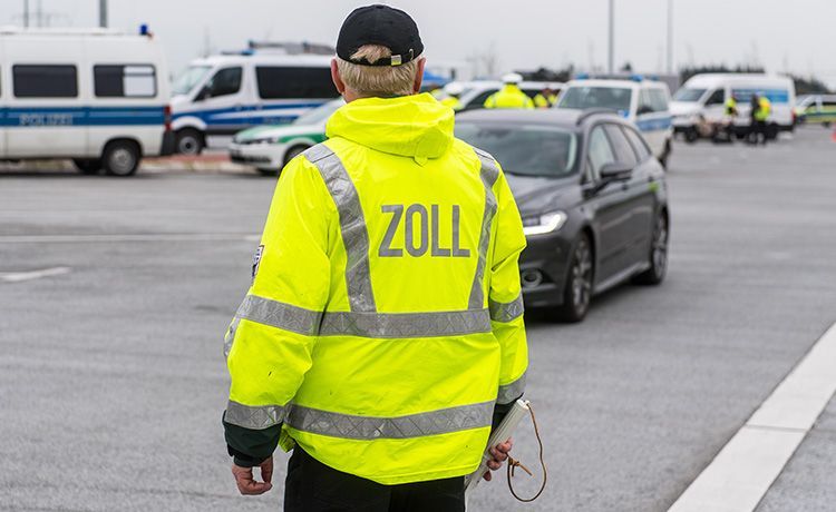 Zollbeamter kontrolliert ein Auto.